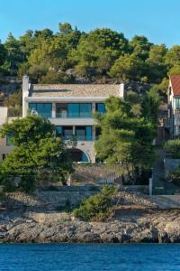 a house on the shore of a body of water at Villa Acona Selca - film star looks in a glamorous setting with amazing facilities in Selca