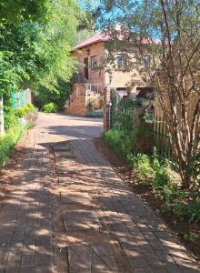a brick road in front of a house at Sebakwe in Dullstroom