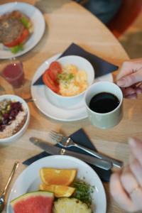 a table with plates of food and a cup of coffee at Comfort Hotel City in Gothenburg
