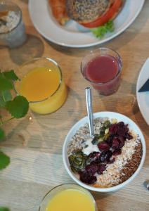 a table with a bowl of breakfast food and drinks at Comfort Hotel City in Gothenburg