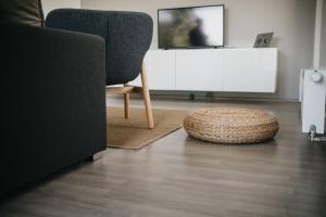 a living room with a chair and a table at Lakepark Residence in Staré Splavy