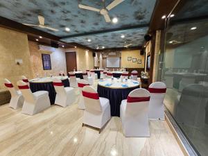 a conference room with tables and chairs in a room at Misty Meadows, Lonavala in Lonavala