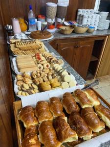 a buffet with various types of bread and pastries at HOTEL DIAMANTE in Resistencia