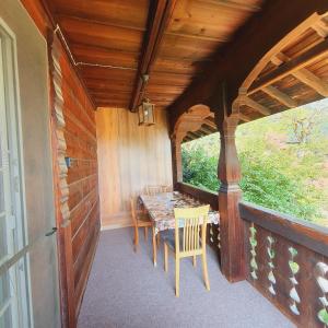 a small porch with a table and chairs on it at Traditional Swiss-Flat in Interlaken