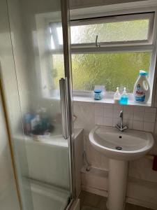 a small bathroom with a sink and a shower at Haven Home in Bristol