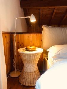 a bedroom with a bed and a table with a lamp at Casa Emy in Adrara San Rocco