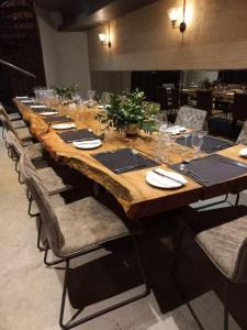 a long table with chairs and a long wooden table at Die Heerenhuys Guest Suites in Stellenbosch
