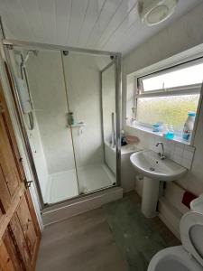 a bathroom with a shower and a sink at Haven Home in Bristol