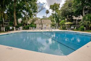a large blue swimming pool in a yard at Windward Village 109 in Hilton Head Island