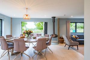 a dining room with a table and chairs at Old Harrow Barn by Bloom Stays in Ashford