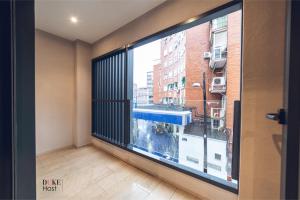a room with a large window with a view of a city at Castilla Luxury 1C Apartment in Madrid