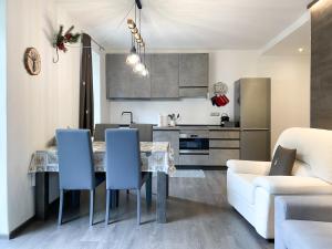 a kitchen and living room with a table and chairs at Angel's Home 4 in Ponte di Legno