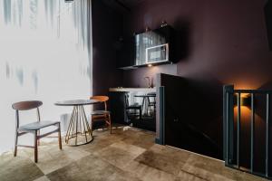 a kitchen with a table and chairs and a counter at De Jonker Urban Suites in Amsterdam