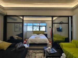 a bedroom with a bed and a couch at luxury studio archit 14 street in Patra