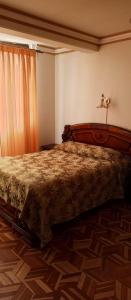 En eller flere senge i et værelse på Hotel el LUCERO
