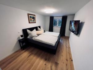 a bedroom with a bed and a television in it at Ferienwohnung Traum am Berg in Zwiesel