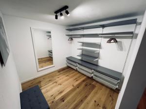 a walk in closet with glass shelves and a mirror at Ferienwohnung Traum am Berg in Zwiesel