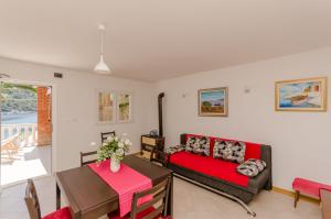 a living room with a couch and a table at House Ancica in Gornje Selo