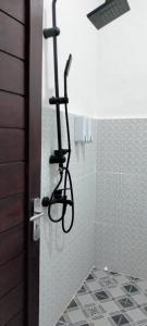 a shower with a bike rack in a bathroom at Giri Swari Homestay in Sidemen