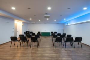 a room with black chairs and a green table at Sarca Lodge Val Rendena in Dare +41 photos