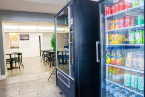 a refrigerator filled with lots of drinks in a restaurant at Howard Johnson by Wyndham Clearwater - Dunedin in Clearwater