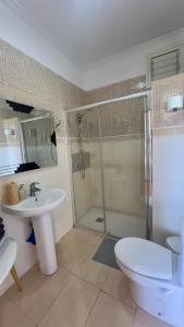 a bathroom with a shower and a sink and a toilet at ALCAMAR Brand apartment with 2 bedroom and private bathroom near the sea! in Alcalá