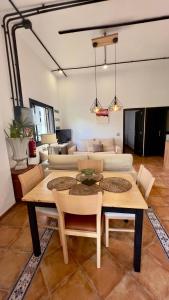 a living room with a table and a couch at ALCAMAR Brand apartment with 2 bedroom and private bathroom near the sea! in Alcalá