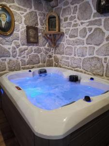 a bath tub with blue water in a stone wall at House Barbara in Lastovo