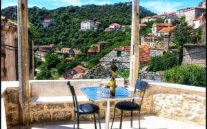 a table and chairs on a balcony with a view at House Barbara in Lastovo
