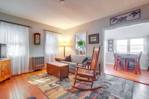 a living room with a couch and a table at Quiet Plymouth Cottage on Great South Pond! in Plymouth