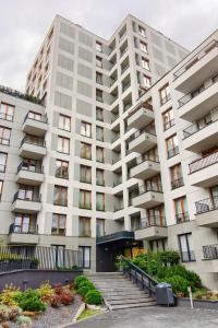 a large white building with stairs in front of it at Cracow City Premium Apartment in Kraków