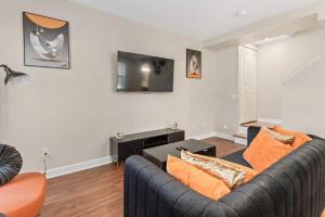 a living room with a couch and a tv at Stylish and Cozy 1-BR Detroit in Detroit