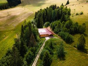 a building in the middle of a field with trees at SKI CIERNY BALOG in Čierny Blh