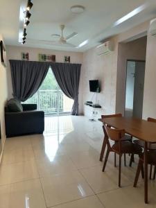 a living room with a couch and a table at Mesahill Nilai 2 Room Condo - Fast wifi, Parking & TV in Nilai