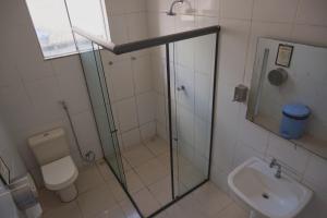 a bathroom with a shower and a toilet and a sink at Belem Hostel in Belém