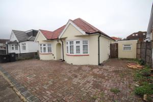 a row of houses on a brick driveway at Deane House in Ruislip