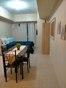 a dining room and living room with a table and chairs at Avida Towers Riala, Tower 2 in Cebu City +46 photos