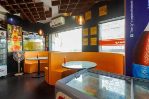 a fast food restaurant with two tables and a window at Collection O 68894 Bommarillu Residency (VIVA Residency) in Trimulgherry