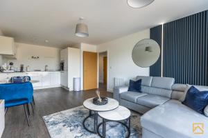 a living room with a couch and a table at Cosy 1 bed near peaceful canal By Valore Property Services in Milton Keynes