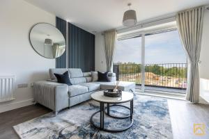 a living room with a couch and a table at Cosy 1 bed near peaceful canal By Valore Property Services in Milton Keynes