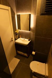 a small bathroom with a sink and a toilet at GRAND İŞBİLİR HOTEL in Nevşehir