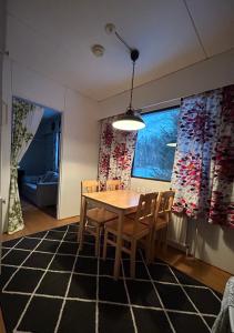 a dining room with a table and chairs at NORVALA The shower is located in the main building in Rovaniemi