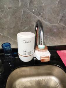 a coffee mug sitting on top of a sink at Balini Home Tiara Desaru in Desaru