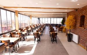 a dining room with tables and chairs and windows at işbilir hotel in Nevşehir +39 photos