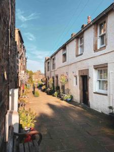 a view of an alley with buildings and a bench at 1700 Period Cottage George Street Addingham in Addingham