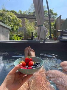 a person holding a bowl of fruit in a swimming pool at 3 George Street Addingham in Addingham
