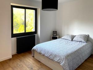 Postel nebo postele na pokoji v ubytování L'Auberge du Ranc