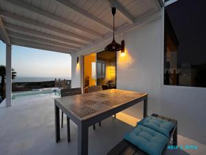 a dining table on a patio with a view of the ocean at CASA TIE' Lanzarote vista mar - piscina relax - adults only in Tías