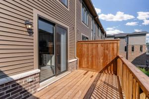a wooden deck with a sliding glass door on a house at Private Room with Lock in Cambridge