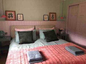 a bedroom with a bed with two towels on it at River Cottage in Turriff